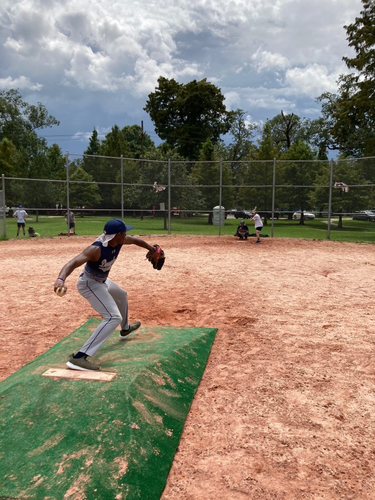 Kelton Castillo of Parleaux Beer Labs throws a pitch to a Crete Street Riot Batter