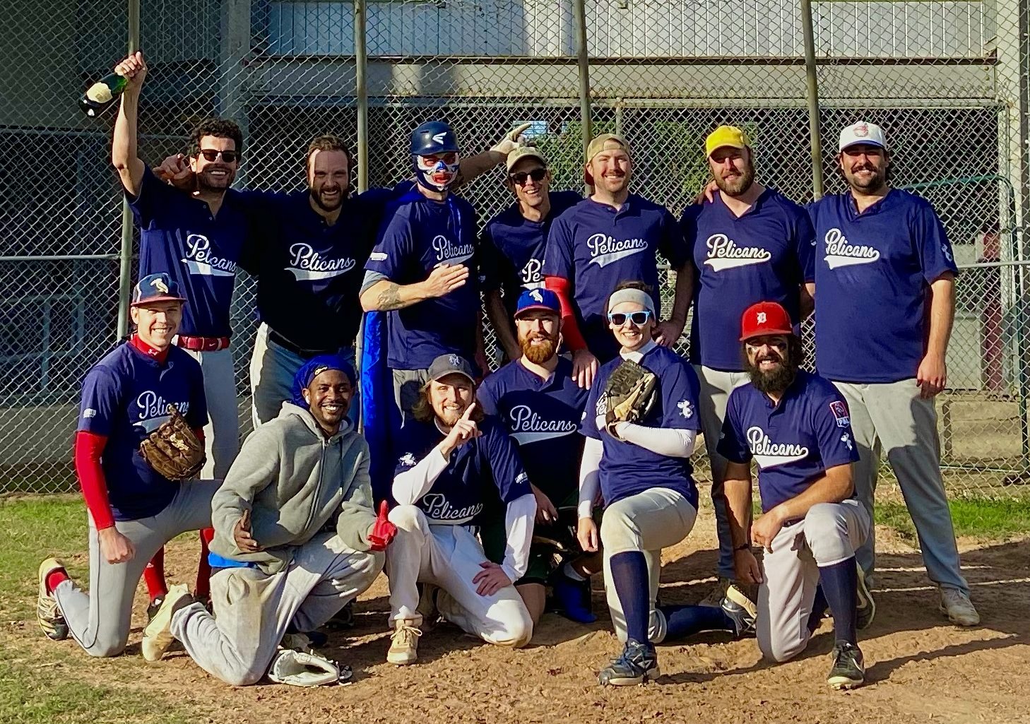 A team photo of the Fall 2022 Champion Pelicans Baseball Club baseball team of the People's Baseball League in New Orleans, LA at Larry Gilbert Stadium in the Hollygrove neighborhood.